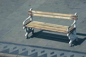 A wooden chair on the side of the road, photo