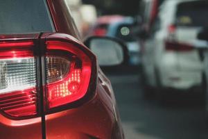 Close up photo of a back lamp of car that stuck in a traffic jam on the highway,