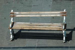 A wooden chair on the side of the road, photo