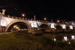 Rome, Italy, the bridge in the night city is beautifully illuminated. photo