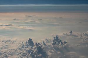 beautiful fluffy clouds from the window of the plane photo