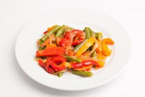 beautiful photo close-up menu of fresh vegetable salad in a plate on a white background