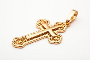 jewelry golden christian cross isolated on white background. photo