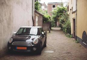 A beautiful mini cooper on the cozy streets of the old town photo