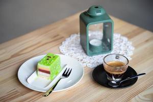 close up a mug of fragrant cappuccino and a sweet dessert on the table photo