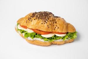 close up croissant with stuffing on a white background photo