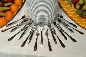 beautiful composition with forks and plates on a buffet table photo