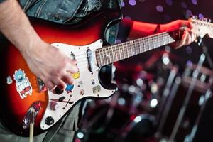 close up play electric guitar at a rock concert photo