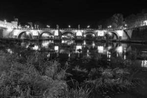 Rome, Italy, the bridge in the night city is beautifully illuminated. photo