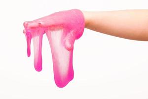 a toy for children mucus and liquid flowing on hand on a white background photo