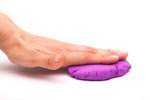 Close-up of a photo in the hands of kinetic sand on a white background