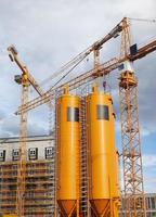 big yellow tanks in the city with cargo cranes in the city. photo