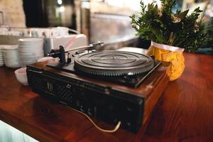 old retro vinyl record player on the table. photo