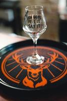 alcohol glass on a tray on a bar with a deer. photo