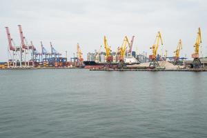 seaport where large cranes are loaded containers on cargo ships photo