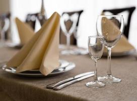 empty goblets and other cutlery are served on the festive table. photo