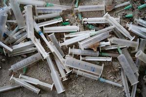 many dirty syringes and needles photo