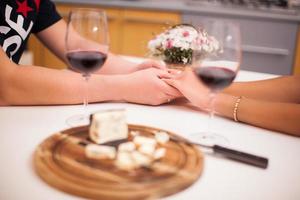 romantic dinner with wine loving couple close up holding hands photo