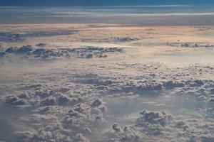 beautiful fluffy clouds from the window of the plane photo