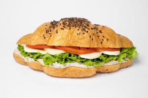 close up croissant with stuffing on a white background photo