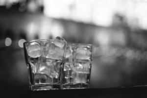 an alcoholic drink with ice is served by the bartender at the bar photo