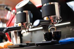 barista makes coffee in a coffee machine photo