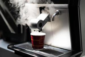 barista makes coffee in a coffee machine photo