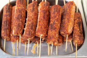 delicious grilled meat sausages on a stick photo