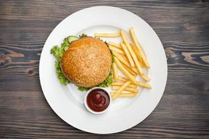 menu with delicious juicy burger and fries with sauce on a plate photo