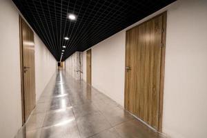 perspective of the empty corridor with many doors photo