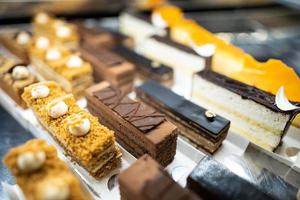 various delicious sweet pastries in the shop window. photo