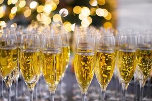 many glasses filled with champagne in celebration of the new year photo