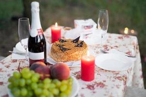 a meeting of lovers, a romantic candlelit dinner and a glass of champagne with sweets. photo