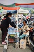 Badung, Bali - January 13 2023 Photo of a seller and a buyer doing a bargain and a transaction between them.