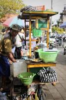 Photo of a pendula preparing his merchandise and waiting for the buyer.