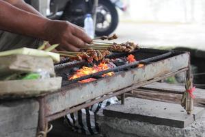 Photo of a pork satay making process in Bali.