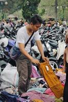 Badung, Bali - January 13 2023 Photo of a seller and a buyer doing a bargain and a transaction between them.