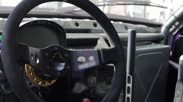 Cabin interior of a modified drift car. Luxury racing sports car. Drift car interior. Focus on the strut, close-up on the wheel and gearshift clutch. video