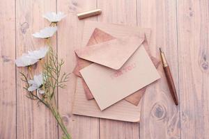 envelope , empty paper and fountain pen on table photo