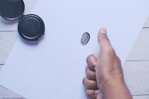 putting fingerprints on a paper close up , photo