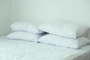 white pillow lined up on bed photo