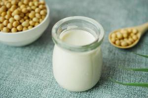 slow motion of soy milk pouring in a glass jar photo