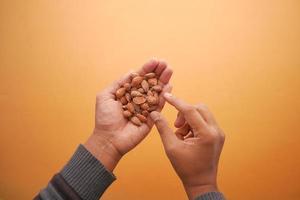 close up of almond nuts on man's hand photo