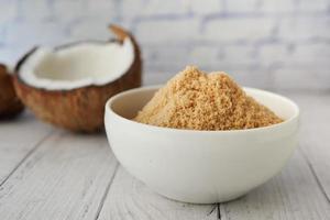 coconut sugar in a white bowl on table photo