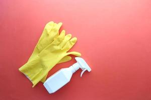 window cleaning spray, brush and gloves on purple background photo