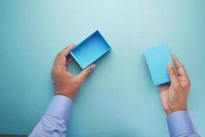 top view of person open a empty small gift box photo