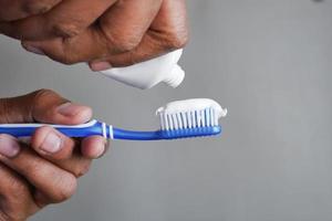 hand holding tooth brush with paste photo