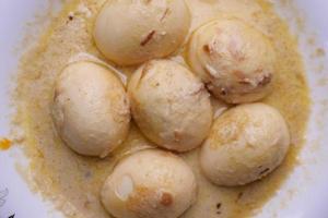 top view of Egg Curry in a bowl on table photo