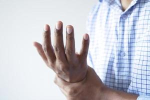 man suffering pain in hand close up photo