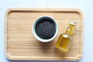Black Cumin seeds oil on table top view photo